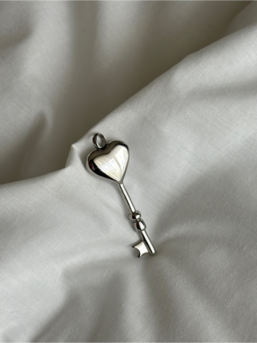 Silver heart-shaped key pendant